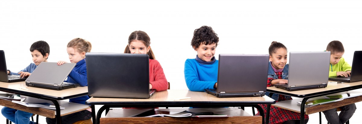 Children in the classroom with laptop computers
